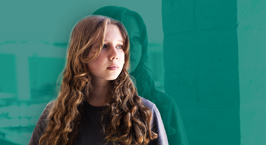 young female with curly hair looking into the distance.